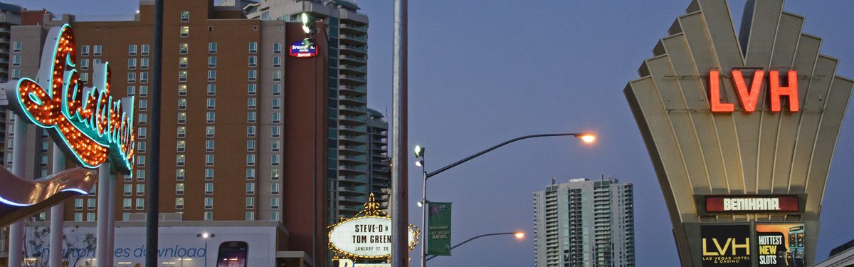 Neon casino signs on the Las Vegas Strip at dusk